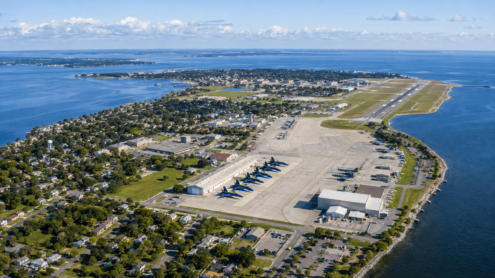 Aerial view of NAS Pensacola along the Gulf Coast with the Blue Angels flight line and surrounding Pensacola Bay neighborhood