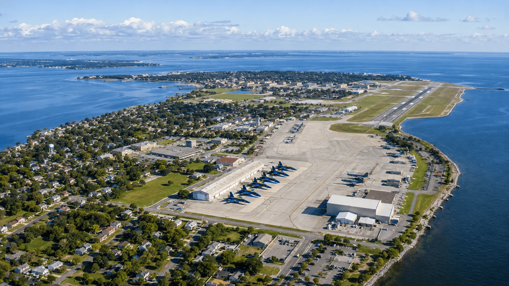 Aerial view of NAS Pensacola along the Gulf Coast with the Blue Angels flight line and surrounding Pensacola Bay neighborhood